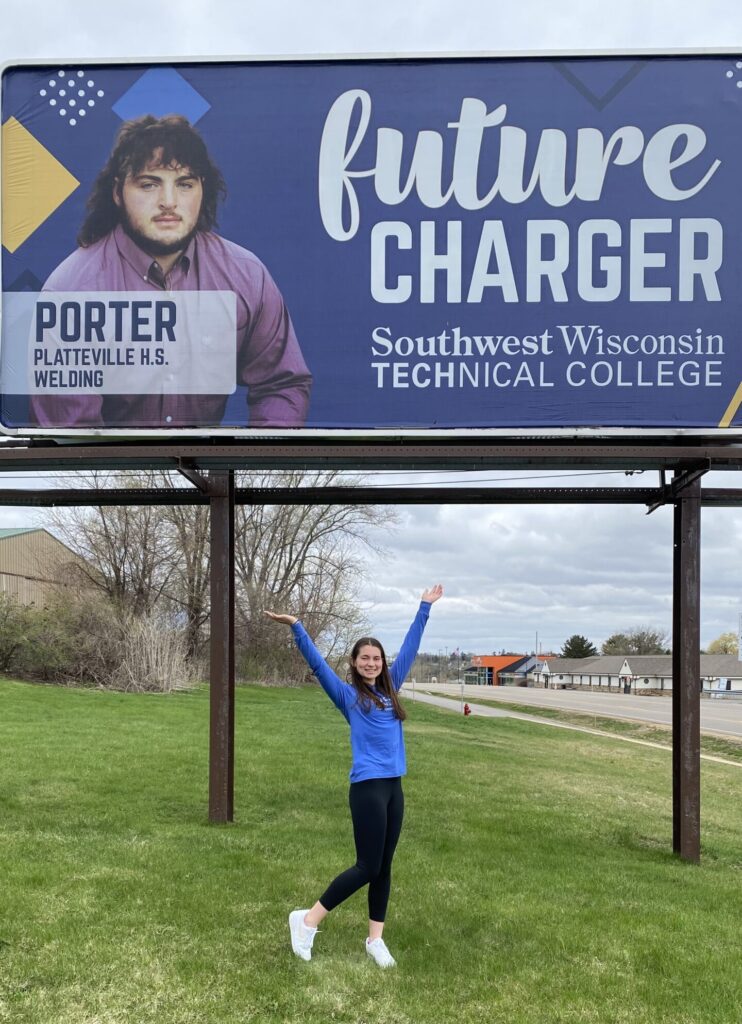 Sabrina pictured in front of her billboard in Platteville, WI